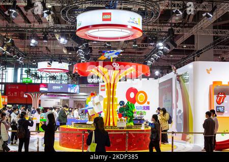 SHANGHAI, CHINA - NOVEMBER 7, 2022 - Visitors experience Lego toys at the booth of the Consumer Goods section of the Fifth International Import Expo ( Stock Photo