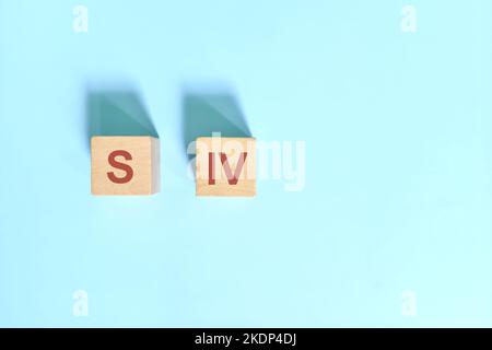 S IV basic sentence pattern English grammar concept. Wooden blocks flat lay on blue background. Stock Photo