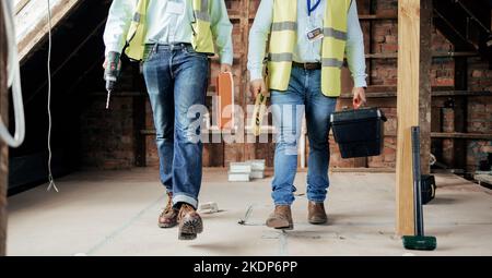 Walking, construction and teamwork with an engineer and designer working on a building site. Industry, developer and collaboration with a construction Stock Photo