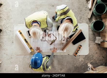 Architect, engineer and teamwork with blueprint from above on a building or contractor project. Building, construction team and architecture design Stock Photo
