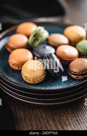 Sweet macaron dessert. Colorful macarons on the plate. Stock Photo