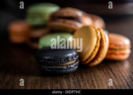 Sweet macaron dessert. Colorful macarons on the wooden table. Stock Photo
