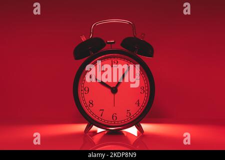 Analog time clock on red light color for times up hurry warning dangerous hours concept Stock Photo