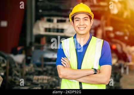 Asian male engineer worker standing arm crossed confident happy smile for enjoy working in factory looking camera Stock Photo