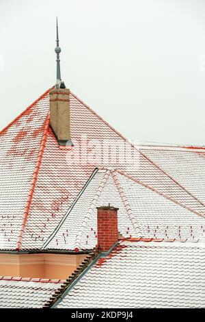 Detail of snow covered roof tiles in city Stock Photo