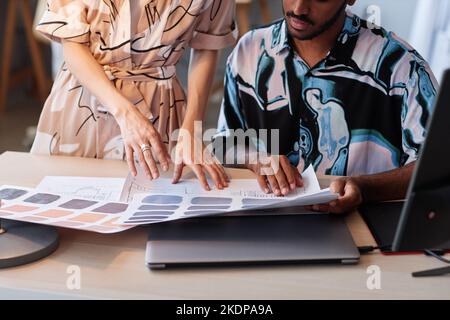 Close up of two creative designers choosing color palettes for interior design project, copy space Stock Photo