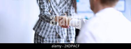 Business partners shaking hands after making good deal Stock Photo
