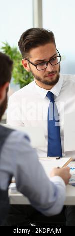 Coworkers men working at financial papers, solve and discuss problems Stock Photo