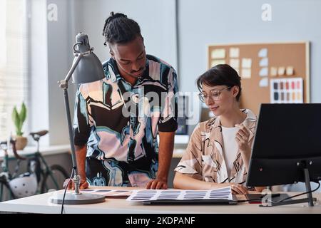 Portrait of two creative designers choosing color palettes at office workplace Stock Photo
