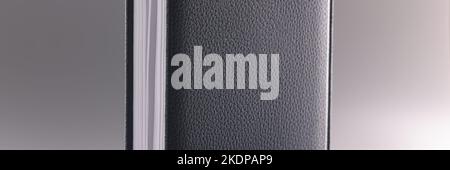 Black leather notebook or diary on grey background Stock Photo