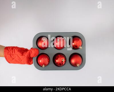 Creative Christmas concept of baking New Year's cookies made of red decoration balls for Christmas tree. Copy space. Stock Photo