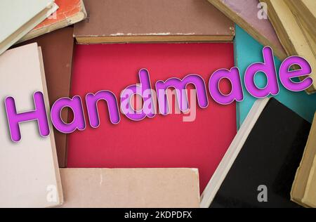 Handmade word in opened book with vintage, natural patterns old antique paper design. Stock Photo