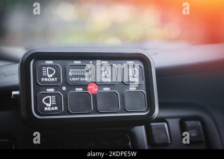 Additional dashboard panel in the car interior to control outdoor custom lighting Stock Photo