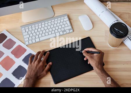 Top view of male designer using pen tablet at workplace, copy space Stock Photo