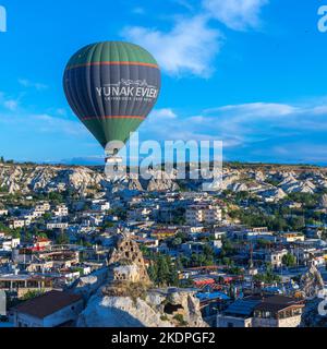 GOREME/TURKEY - June 27, 2022:  hot air balloons fly over the town Stock Photo