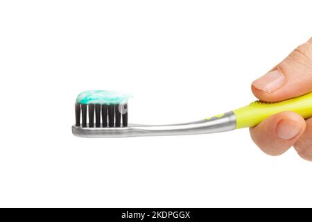 Female hand holding toothbrush with toothpaste isolated on white background. Stock Photo