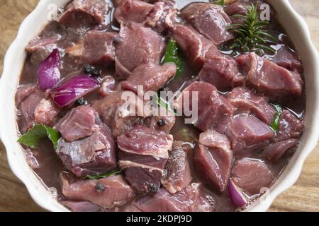 wild boar meat to macerate inred  wine with herbs Stock Photo