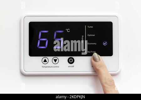 Domestic boiler control panel with economy mode enabled. The concept of saving and careful use of resources. Stock Photo