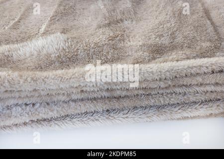 New folded brown fleece throw blanket, fabric closeup, copy space Stock Photo
