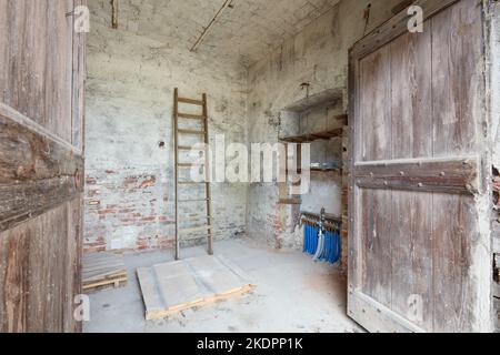 Old depository room with wooden portal in old country house Stock Photo