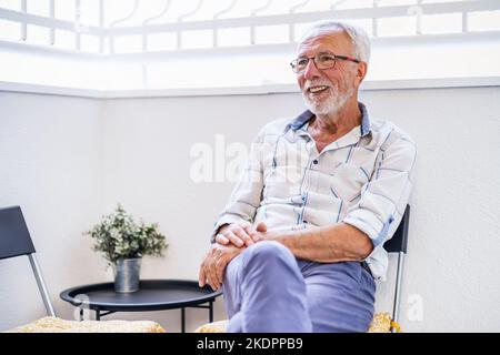 Senior man sitting on terrace and enjoying fresh air. Leisure time. Stock Photo