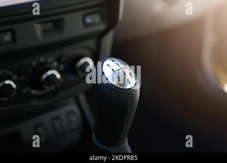 Close up view of a gear lever shift. Manual gearbox. Car interior details. Car transmission. Soft lighting. Stock Photo