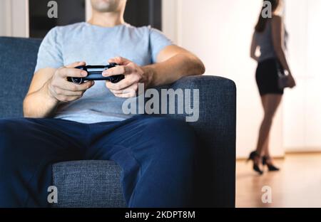Cheerful boyfriend and girlfriend playing video games to win. Happy couple  using controller to play online game and winning gameplay on console.  People holding joystick to have fun Stock Photo - Alamy