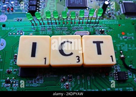 ICT - Information & Communication Technology - Scrabble letters / word on a electronic PCB Stock Photo