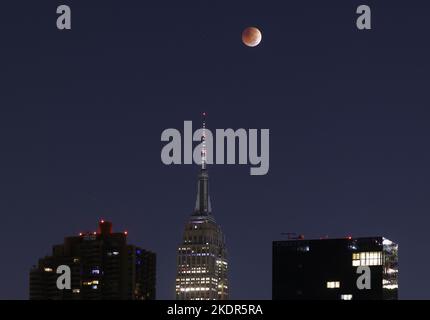 Full Moon behind Empire State Building Stock Photo - Alamy