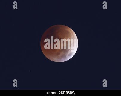 New York, United States. 08th Nov, 2022. A full blood moon sets behind the Manhattan skyline during a total lunar eclipse in New York City on Tuesday, November 8, 2022. A total lunar eclipse occurs approximately once every 1 ½ years on average, with the next total lunar eclipse not taking place until March 14, 2025. Photo by John Angelillo/UPI Credit: UPI/Ģ����ý Live News Stock Photo