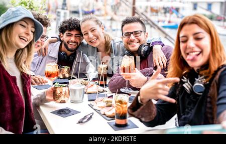 Trendy friends taking selfie at bar restaurant dehor out side - Life style concept with young people having fun together on happy hour Stock Photo