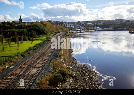 railway tracks along the river foyle leading to waterside train station derry londonderry northern ireland uk Stock Photo