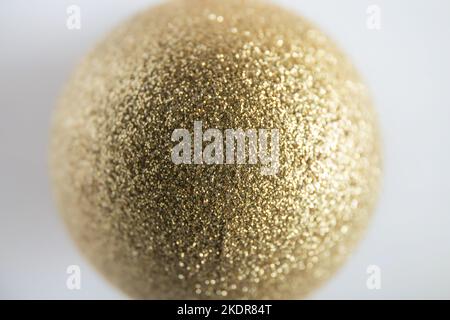 Shallow depth of field of gold glitter colored Christmas bauble. Christmas background concept. Stock Photo