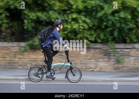 A man riding a Brompton folding bicycle along Waterloo Road, London, UK.  16 Oct 2022 Stock Photo