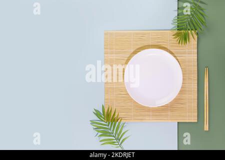 Eco friendly Mock up for display or montage of dishes or food. Minimalistic, oriental style composition with an empty plate on nature mat with wooden Stock Photo