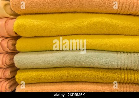 Set pile stacked yellow bright color fabric towels object hygiene bathroom concept, close up. Stock Photo