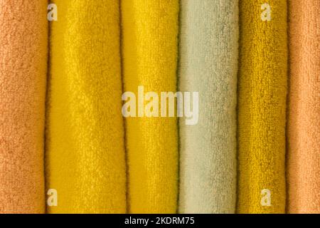 Set pile stacked yellow bright color fabric towels object hygiene bathroom concept, close up. Stock Photo