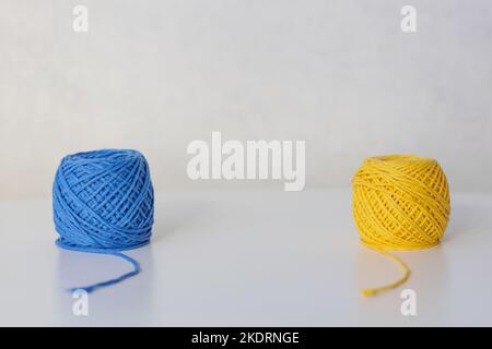 Close-up of yellow and blue balls placed at different angles with space in between Stock Photo