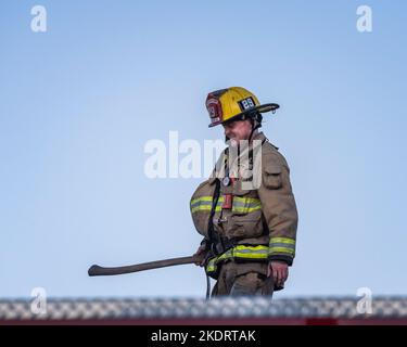 Los Angeles, CA, USA – November 3, 2022: Los Angeles Fire Department firefighters put out a house fire on Martel street in Los Angeles, CA. Stock Photo