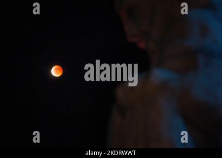 Antipolo, Philippines. 08th Nov, 2022. General view of Beaver Blood Moon during it's totality in Antipolo Cathedral. Beaver Blood Moon is the last total lunar eclipse for the year 2022. The next full lunar eclipse will be occurring on March 24, 2025. Total lunar eclipse happens when Earth's shadow covers the moon due to its perfect alignment between the sun and the moon, causing it to take on a reddish hue. (Photo by Ryan Eduard Benaid/SOPA Images/Sipa USA) Credit: Sipa USA/Ģ����ý Live News Stock Photo