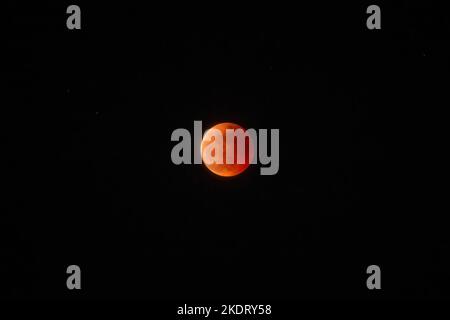 Antipolo, Rizal, Philippines. 8th Nov, 2022. General view of Beaver Blood Moon during it's totality in Antipolo Cathedral. Beaver Blood Moon is the last total lunar eclipse for the year 2022. The next full lunar eclipse will be occurring on March 24, 2025. Total lunar eclipse happens when Earth's shadow covers the moon due to its perfect alignment between the sun and the moon, causing it to take on a reddish hue. (Credit Image: © Ryan Eduard Benaid/SOPA Images via ZUMA Press Wire) Credit: ZUMA Press, Inc./Ģ����ý Live News Stock Photo