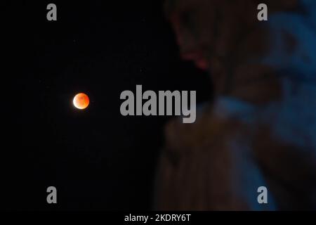 Antipolo, Rizal, Philippines. 8th Nov, 2022. General view of Beaver Blood Moon during it's totality in Antipolo Cathedral. Beaver Blood Moon is the last total lunar eclipse for the year 2022. The next full lunar eclipse will be occurring on March 24, 2025. Total lunar eclipse happens when Earth's shadow covers the moon due to its perfect alignment between the sun and the moon, causing it to take on a reddish hue. (Credit Image: © Ryan Eduard Benaid/SOPA Images via ZUMA Press Wire) Credit: ZUMA Press, Inc./Ģ����ý Live News Stock Photo