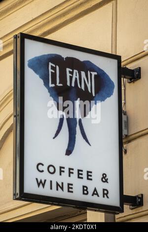 Helsinki, Finland - July 19, 2022: Closeup of black and blue on white El Fant coffee and wine bar emblem above entrance against yellow facade on Katar Stock Photo