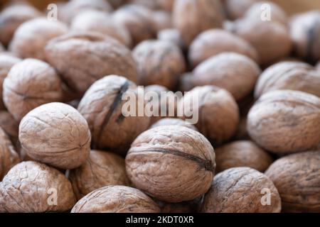 Walnut background. Group of walnuts, narrow depth of field. Focus on the walnuts in front Stock Photo