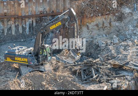 Helsinki, Finland - July 19, 2022: Closeup of destruction heavy duty Kreate scoop crane working in construction site adjacent to quay at Katanaokanlai Stock Photo