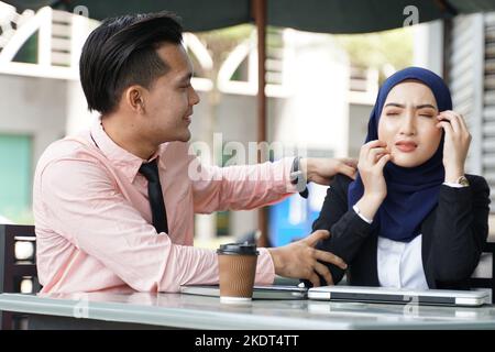 Sick young businesswoman having allergic reaction or seasonal infection, rash and scracthing with her friend partner colleague feeling worried. Stock Photo