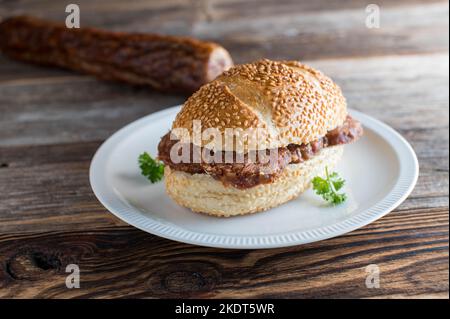 Sesame seed bun with homemade salami. Traditional german sandwich Stock Photo