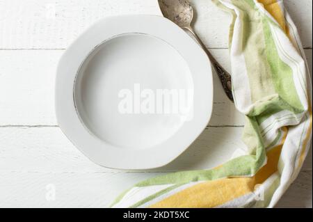 Empty soup plate on white background with spoon Stock Photo