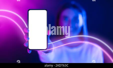 Happy long-haired woman showing smartphone with empty screen, copy space Stock Photo