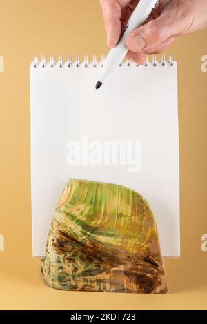 A table stand made of stabilized maple wood with a white label on a yellow background. Space for copying.To showcase products or photo frames. layout Stock Photo